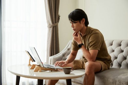 Man Reading E-mail on Laptop